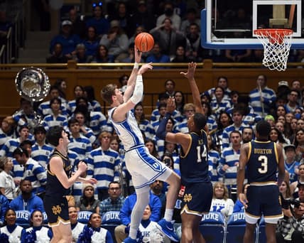Feb 7, 2024; Durham, North Carolina, USA;  Duke Blue Devils center Kyle Filipowski (30) shoots over Notre Dame Fighting Irish forwar Kebba Nije (14) during the first half at Cameron Indoor Stadium. Mandatory Credit: Rob Kinnan-USA TODAY Sports