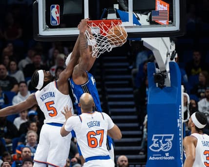 Feb 14, 2024; Orlando, Florida, USA; Orlando Magic forward Paolo Banchero (5) dunks the ball against New York Knicks forward Precious Achiuwa (5) in the second quarter at KIA Center. Mandatory Credit: Jeremy Reper-USA TODAY Sports