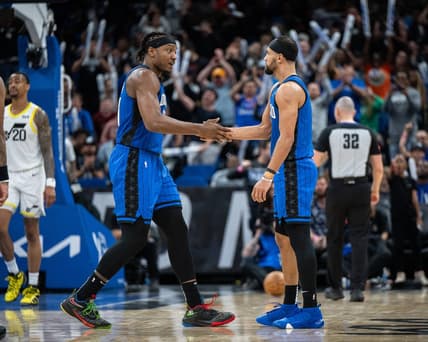 Feb 29, 2024; Orlando, Florida, USA; Orlando Magic center Wendell Carter Jr. (34) and guard Jalen Suggs (4) celebrate a three pointer against the Utah Jazz in the fourth quarter at Kia Center. Mandatory Credit: Jeremy Reper-USA TODAY Sports