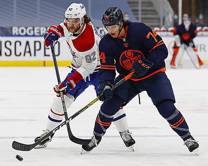 Apr 21, 2021; Edmonton, Alberta, CAN; Edmonton Oilersdefensemen Ethan Bear (74) and Montreal Canadiens forward Jonathan Drouin (92) battle for a loose puck during the first period at Rogers Place. Mandatory Credit: Perry Nelson-USA TODAY Sports