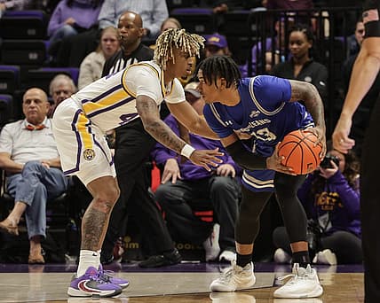 Nov 17, 2022; Baton Rouge, Louisiana, USA; New Orleans Privateers guard Jamond Vincent (13) looks to pass the ball against LSU Tigers guard Adam Miller (44) during the first half at Pete Maravich Assembly Center. Mandatory Credit: Stephen Lew-USA TODAY Sports