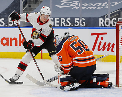 Jan 31, 2021; Edmonton, Alberta, CAN; Edmonton Oilers goaltender Stuart Skinner (50) makes a save against Ottawa Senators forward Brady Tkachuk (7) during the second period at Rogers Place. Mandatory Credit: Perry Nelson-USA TODAY Sports