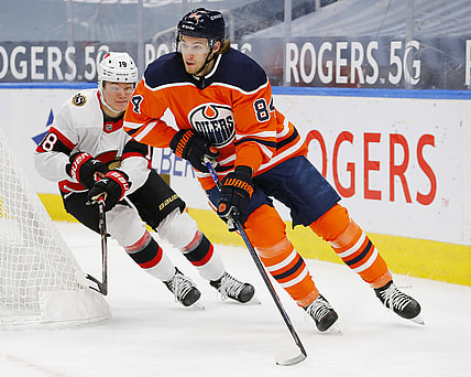 Feb 2, 2021; Edmonton, Alberta, CAN; Ottawa Senators forward Tim Stuetzle (18) chases Edmonton Oilers defensemen William Lagesson (84) during the second period at Rogers Place. Mandatory Credit: Perry Nelson-USA TODAY Sports