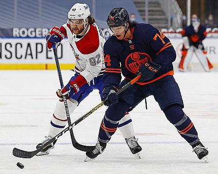 Apr 21, 2021; Edmonton, Alberta, CAN; Edmonton Oilersdefensemen Ethan Bear (74) and Montreal Canadiens forward Jonathan Drouin (92) battle for a loose puck during the first period at Rogers Place. Mandatory Credit: Perry Nelson-USA TODAY Sports
