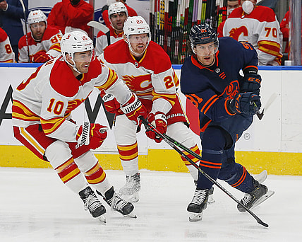 Apr 29, 2021; Edmonton, Alberta, CAN; Calgary Flames forward Derek Ryan (10) and Edmonton Oilers forward Gaetan Haas (91) look for a loose puck during the first period at Rogers Place. Mandatory Credit: Perry Nelson-USA TODAY Sports