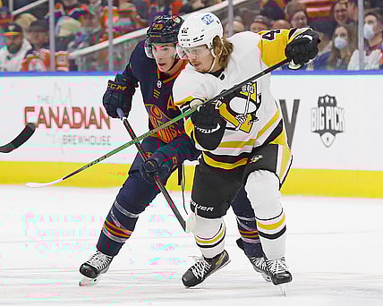 Dec 1, 2021; Edmonton, Alberta, CAN; Pittsburgh Penguins forward Kasperi Kapanen (42) and Edmonton Oilers forward Ryan Nugent-Hopkins (93) battle for a loose puck during the first period at Rogers Place. Mandatory Credit: Perry Nelson-USA TODAY Sports