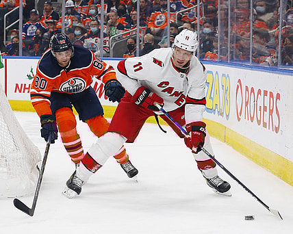 Dec 11, 2021; Edmonton, Alberta, CAN; Carolina Hurricanes forward Jordan Staal (11) looks to make a pas in front of Edmonton Oilers defensemen Markus Neimelainen (80) during the second period at Rogers Place. Mandatory Credit: Perry Nelson-USA TODAY Sports