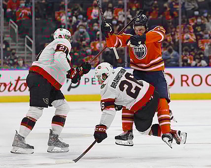 Jan 15, 2022; Edmonton, Alberta, CAN; Edmonton Oilers forward Zach Hyman (18) checks Ottawa Senators defensemen Erik Brannstrom (26) during the third period at Rogers Place. Mandatory Credit: Perry Nelson-USA TODAY Sports