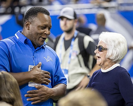 Sep 11, 2022; Detroit, Michigan, USA; Former Detroit Lions Barry Sanders chat with Owner/Chair Emeritus of the Detroit Lions Martha Firestone Ford before the start of the NFL game against the Philadelphia Eagles at Ford Field. Mandatory Credit: David Reginek-USA TODAY Sports