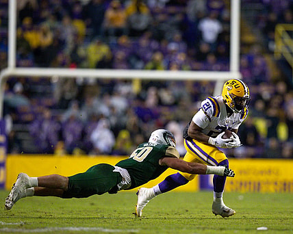 Nov 19, 2022; Baton Rouge, Louisiana, USA;  LSU Tigers running back Noah Cain (21) rushes against UAB Blazers linebacker Noah Wilder (50) during the first half at Tiger Stadium. Mandatory Credit: Stephen Lew-USA TODAY Sports