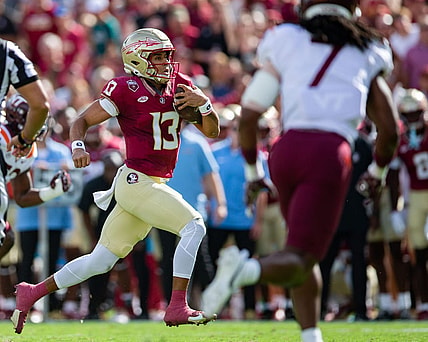Florida State Seminoles quarterback Jordan Travis (13) makes a dash towards the end zone. The Florida State Seminoles lead the Virginia Tech Hokies 22-10 at the half on Saturday, Oct. 7, 2023.