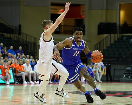 Nov 23, 2023; Kissimmee, FL, USA;  Boise State Broncos guard Chibuzo Agbo (11) drives past Virginia Tech Hokies guard Sean Pedulla (3) in the first half during the ESPN Events Invitational at State Farm Field House. Mandatory Credit: Nathan Ray Seebeck-USA TODAY Sports