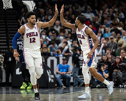 Dec 27, 2023; Orlando, Florida, USA; Philadelphia 76ers forward Tobias Harris (12) and small guard De'Anthony Melton (8) celebrate a turnover against the Orlando Magic in the fourth quarter at Kia Center. Mandatory Credit: Jeremy Reper-USA TODAY Sports