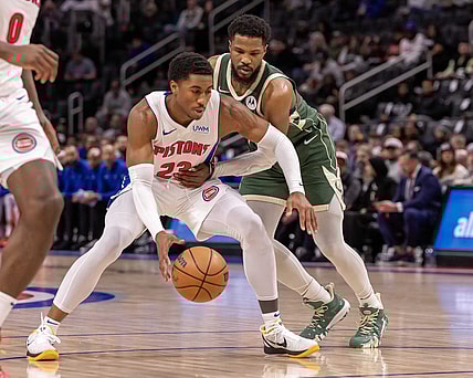 Jan 22, 2024; Detroit, Michigan, USA; Detroit Pistons guard Jaden Ivey (23) protects the ball from Milwaukee Bucks guard Malik Beasley (5) during the first quarter at Little Caesars Arena. Mandatory Credit: David Reginek-USA TODAY Sports