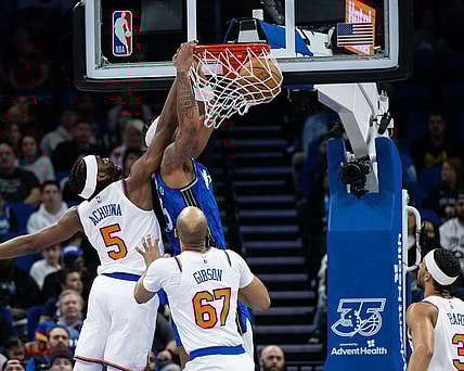 Feb 14, 2024; Orlando, Florida, USA; Orlando Magic forward Paolo Banchero (5) dunks the ball against New York Knicks forward Precious Achiuwa (5) in the second quarter at KIA Center. Mandatory Credit: Jeremy Reper-USA TODAY Sports