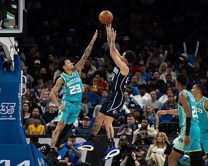 Mar 19, 2024; Orlando, Florida, USA; Orlando Magic guard Cole Anthony (50) shoots the ball over Charlotte Hornets guard Tre Mann (23) in the fourth quarter at KIA Center. Mandatory Credit: Jeremy Reper-USA TODAY Sports
