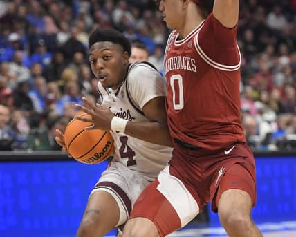 Mar 10, 2023; Nashville, TN, USA; Texas A&M Aggies guard Wade Taylor IV (4) drives past Arkansas Razorbacks guard Anthony Black (0) during the second half at Bridgestone Arena. Mandatory Credit: Steve Roberts-USA TODAY Sports