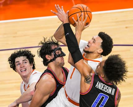 Sunday, November 19, 2023; Clemson senior guard Chase Hunter (1) scores near Boise State forward Tyson Degenhart (2) during the first half at Littlejohn Coliseum in Clemson, S.C. Sunday, November 19, 2023.  Mandatory Credit: Ken Ruinard-USA TODAY NETWORK
