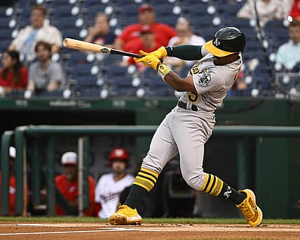 Aug 30, 2022; Washington, District of Columbia, USA; Oakland Athletics left field Tony Kemp (5) hits a double against the Washington Nationals during the first inning at Nationals Park. Mandatory Credit: Brad Mills-USA TODAY Sports