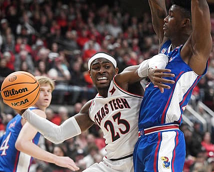 Texas Tech guard De'Vion Harmon (23), center, passes the ball against Kansas during the Big 12 basketball game, Tuesday, Jan. 3, 2023, at United Supermarkets Arena.