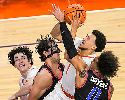 Sunday, November 19, 2023; Clemson senior guard Chase Hunter (1) scores near Boise State forward Tyson Degenhart (2) during the first half at Littlejohn Coliseum in Clemson, S.C. Sunday, November 19, 2023.  Mandatory Credit: Ken Ruinard-USA TODAY NETWORK