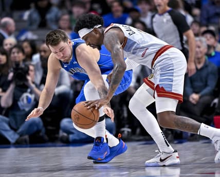 Nov 18, 2022; Dallas, Texas, USA; Dallas Mavericks guard Luka Doncic (77) and Denver Nuggets guard Kentavious Caldwell-Pope (5) battle for the loose ball during the second quarter at the American Airlines Center. Mandatory Credit: Jerome Miron-USA TODAY Sports