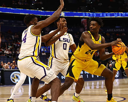 Mar 10, 2022; Tampa, FL, USA;Missouri Tigers forward Kobe Brown (24) drives to the basket as LSU Tigers guard Brandon Murray (0) and LSU Tigers forward Darius Days (4) defend during the first half at Amalie Arena. Mandatory Credit: Kim Klement-USA TODAY Sports