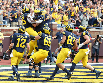 Michigan running back Blake Corum celebrates with teammates after his touchdown against Western Michigan during the first half in Ann Arbor on Saturday, Sept. 4, 2021.

Mich West