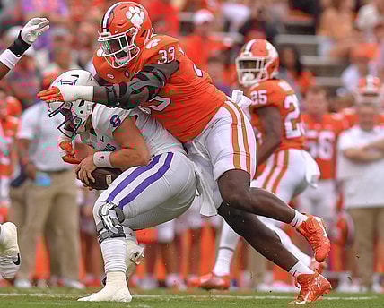Sep 10, 2022; Clemson, South Carolina, USA;  Clemson Tigers defensive tackle Ruke Orhorhoro (33) tackles Furman Paladins quarterback Tyler Huff (6) during the first quarter at Memorial Stadium. Mandatory Credit: Ken Ruinard-USA TODAY Sports