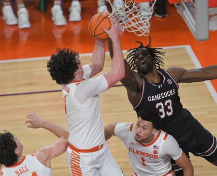 Dec 6, 2023; Clemson, South Carolina, USA; Clemson junior forward Ian Schieffelin (4) rebounds ear University of South Carolina forward Josh Gray (33) during the first half   at Littlejohn Coliseum. Mandatory Credit: Ken Ruinard-USA TODAY Sports
