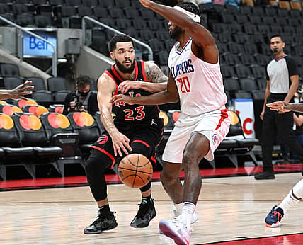 Dec 31, 2021; Toronto, Ontario, CAN; Toronto Raptors guard Fred VanVleet (23) passes the ball past Los Angeles Clippers guard Justise Winslow (20) in the first half at Scotiabank Arena. Mandatory Credit: Dan Hamilton-USA TODAY Sports