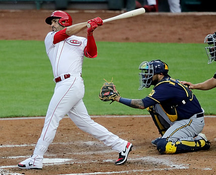 Jul 16, 2021; Cincinnati, Ohio, USA; Cincinnati Reds third baseman Eugenio Suarez (7) hits a two-run double against the Milwaukee Brewers during the third inning at Great American Ball Park. Mandatory Credit: David Kohl-USA TODAY Sports