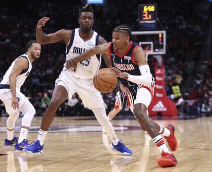 Jan 7, 2022; Houston, Texas, USA; Houston Rockets guard Jalen Green (0) dribbles the ball as Dallas Mavericks forward Reggie Bullock (25) defends during the second quarter at Toyota Center. Mandatory Credit: Troy Taormina-USA TODAY Sports