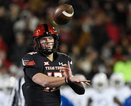 Texas Tech's quarterback Tyler Shough (12) throws a pass to Texas Tech's tight end Mason Tharp (80) for a touchdown against Kansas in a Big 12 football game, Saturday, Nov. 12, 2022, at Jones AT&T Stadium.