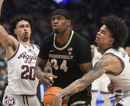 Mar 11, 2023; Nashville, TN, USA;  Texas A&M Aggies forward Andersson Garcia (11) slaps the ball from Vanderbilt Commodores forward Lee Dort (34) during the first half at Bridgestone Arena. Mandatory Credit: Steve Roberts-USA TODAY Sports