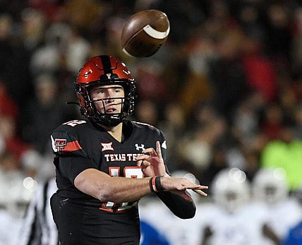 Texas Tech's quarterback Tyler Shough (12) throws a pass to Texas Tech's tight end Mason Tharp (80) for a touchdown against Kansas in a Big 12 football game, Saturday, Nov. 12, 2022, at Jones AT&T Stadium.