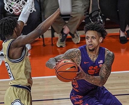 Jan 24, 2023; Clemson, South Carolina, USA; Clemson Tigers guard Brevin Galloway (11) moves the ball against Georgia Tech Yellow Jackets forward Jordan Meka (23) during the first half at Littlejohn Coliseum. Mandatory Credit: Ken Ruinard-USA TODAY Sports