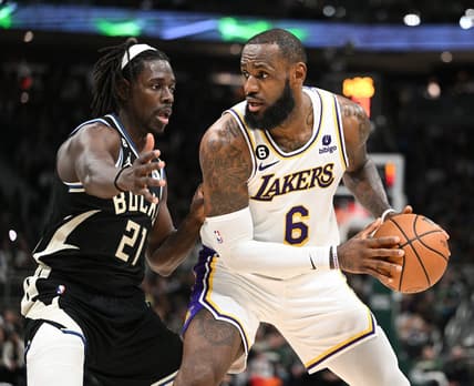 Dec 2, 2022; Milwaukee, Wisconsin, USA; Los Angeles Lakers forward LeBron James (6) posts up against Milwaukee Bucks guard Jrue Holiday (21) in the second quarter at Fiserv Forum. Mandatory Credit: Michael McLoone-USA TODAY Sports