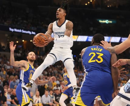 May 1, 2022; Memphis, Tennessee, USA; Memphis Grizzlies guard Ja Morant (12) attempts a layup against the Golden State Warriors during Game 1 of the second round for the 2022 NBA playoffs at FedExForum. Mandatory Credit: Joe Rondone-USA TODAY Sports
