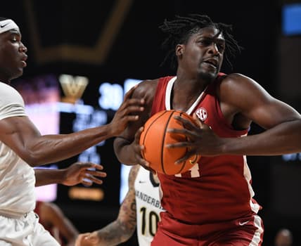 Jan 17, 2023; Nashville, Tennessee, USA; Alabama Crimson Tide center Charles Bediako (14) attempts a shot against Vanderbilt Commodores forward Lee Dort (left) during the second half at Memorial Gymnasium. Mandatory Credit: Christopher Hanewinckel-USA TODAY Sports