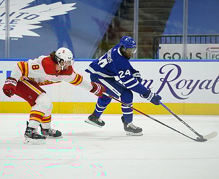 Apr 13, 2021; Toronto, Ontario, CAN; Calgary Flames defenseman Christopher Tanev (8) defends against Toronto Maple Leafs forward Wayne Simmonds (24) during the first period at Scotiabank Arena. Mandatory Credit: John E. Sokolowski-USA TODAY Sports