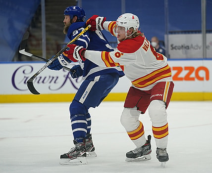 Apr 13, 2021; Toronto, Ontario, CAN; Calgary Flames defenseman Juuso Valimaki (6) battles for position with Toronto Maple Leafs forward Joe Thornton (97) during the first period at Scotiabank Arena. Mandatory Credit: John E. Sokolowski-USA TODAY Sports