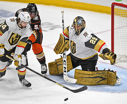 Apr 18, 2021; Anaheim, California, USA; Vegas Golden Knights goaltender Marc-Andre Fleury (29) defends the net as Vegas Golden Knights defenseman Nicolas Hague (14) knocks away a shot on goal by Anaheim Ducks center Adam Henrique (14) in the third period of the game at Honda Center. Mandatory Credit: Jayne Kamin-Oncea-USA TODAY Sports