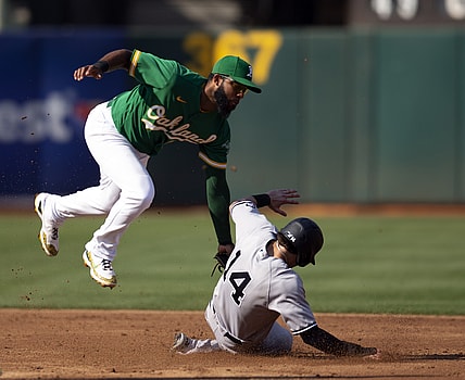 Aug 29, 2021; Oakland, California, USA; Oakland Athletics shortstop Elvis Andrus (17) leaves his feet to tag out New York Yankees shortstop Tyler Wade (14) on a stolen base attempt during the third inning at RingCentral Coliseum. Mandatory Credit: D. Ross Cameron-USA TODAY Sports
