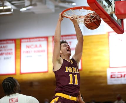 Iona's Quinn Slazinski slam dunks on Marist's Victor Enoh during Wednesday's game in Poughkeepsie on December 1, 2021.

Marist Vs Iona Basketball