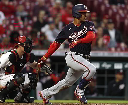 Sep 23, 2021; Cincinnati, Ohio, USA; Washington Nationals right fielder Juan Soto (22) hits a single against the Cincinnati Reds during the third inning at Great American Ball Park. Mandatory Credit: David Kohl-USA TODAY Sports