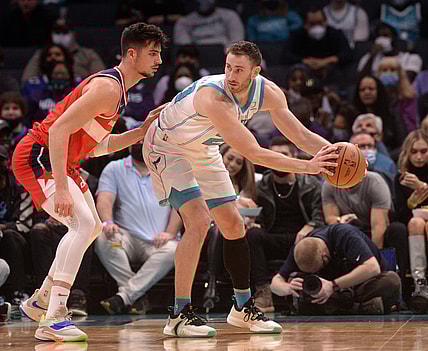 Nov 17, 2021; Charlotte, North Carolina, USA; Charlotte Hornets guard forward Gordon Hayward (20) looks to pass as he is defended by Washington Wizards forward Deni Avdija (9) during the first half at the Spectrum Center. Mandatory Credit: Sam Sharpe-USA TODAY Sports