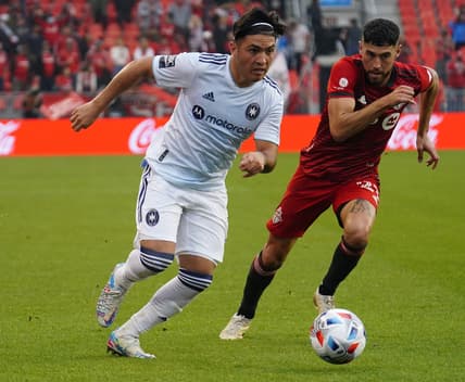 Oct 3, 2021; Toronto, Ontario, CAN; Chicago Fire forward Ignacio Aliseda (7) gets by Toronto FC midfielder Jonathan Osorio (21) during the second half at BMO Field. Mandatory Credit: John E. Sokolowski-USA TODAY Sports