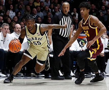 Purdue Boilermakers guard Lance Jones (55) drives past Minnesota Golden Gophers guard Cam Christie (24) during the NCAA men   s basketball game, Thursday, Feb. 15, 2024, at Mackey Arena in West Lafayette, Ind. Purdue Boilermakers won 84-76.