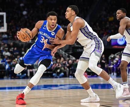 Dec 7, 2022; Milwaukee, Wisconsin, USA; Milwaukee Bucks forward Giannis Antetokounmpo (34) drives for the basket against Sacramento Kings forward Keegan Murray (13) in the first quarter at Fiserv Forum. Mandatory Credit: Benny Sieu-USA TODAY Sports